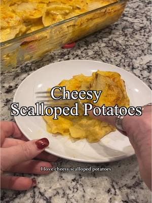 This cheesy scalloped potatoes recipe is a comforting and hearty dish, perfect as a side or even a main course. Using a mandolin and a cheese grater makes prep quick and easy. Here’s how to make it: Ingredients: •	8 cups potatoes (about 3 pounds), peeled and sliced very thin (⅛ inch thick) •	4 tablespoons butter •	½ cup diced onion •	1 teaspoon minced garlic •	6 tablespoons flour •	1 cup chicken broth •	2 cups milk •	Salt and pepper, to taste •	1 cup cheddar cheese, grated Instructions: 1.	Prep the Potatoes & Pan •	Spray a 9×13 baking dish with nonstick spray and preheat your oven to 350°F. •	Wash, dry, and peel the potatoes. Use a mandolin or slicer attachment to slice them very thin (about ⅛ inch thick). 2.	Make the Sauce •	In a large saucepan over medium-low heat, melt the butter. Add the diced onion and garlic, cooking until softened (about 3–4 minutes). •	Sprinkle in the flour, whisking to combine, and cook for another 2 minutes. •	Reduce the heat to low and slowly whisk in the chicken broth. Gradually add the milk while continuing to whisk. •	Increase the heat to medium, stirring constantly until the mixture comes to a boil and thickens. Season with salt and pepper to taste. •	Remove from heat and stir in the grated cheddar cheese until fully melted. 3.	Assemble the Dish •	Arrange half of the sliced potatoes in a single layer in the prepared pan. Season lightly with salt and pepper. •	Pour half of the cheese sauce evenly over the potatoes. •	Layer the remaining potatoes on top, season again with salt and pepper, and pour the rest of the sauce over them. 4.	Bake the Potatoes •	Cover the dish with foil and bake for 45 minutes. •	Remove the foil and bake for another 30–40 minutes, or until the potatoes are tender and golden on top. 5.	Rest and Serve 	•	Remove the dish from the oven and let the scalloped potatoes sit for 10–15 minutes to set before serving. Enjoy this creamy, cheesy dish—it’s perfect for any occasion! #DeliciouslyBold #ScallopedPotatoes #CheesyPotatoes #ComfortFood #EasyRecipes #HomemadeMeals #PotatoRecipes #SideDishInspo #FamilyFavorites #DinnerIdeas #CozyEats #CheeseLovers #CreamyPotatoes #SimpleIngredients #FoodBlogging #CookingAtHome 