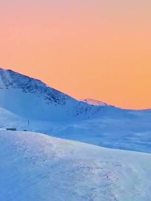 Warm, vibrant sunset of pink and gold paints the sky over the Yekaxia ski resort in Altay, Xinjiang, creating a breathtakingly romantic scene.  #wonderfulChina #amazingChina #travelinChina #ski #resort #northwestChina #XinjiangUygurAutonomousRegion