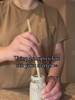 Stirring my sourdough starter with a chopstick because it’s the ultimate multitasker—mixes perfectly and cleans up like a dream! Who knew simplicity could be so satisfying? What’s your go-to starter tool? 👩‍🍳🥖 - - - - - -  #SourdoughStarter #BakingTips #ChopstickHack #SourdoughLove #HomemadeBread #BreadBaking #KitchenHacks #StarterCare #SourdoughLife #BreadMaking #SmallBatchBaking #BakingFromScratch #FermentationStation #SourdoughCommunity #HomeBakers #SourdoughAddict #BakingIdeas #SourdoughGoals #BreadLovers #BakingInspiration