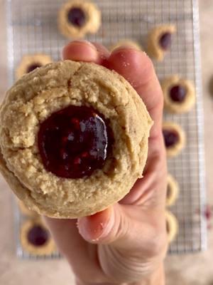 Super simple cookie recipe. Peanut butter thumbprint with raspberry jam #supersimple #cookiedough #pbj #easybaking #girldessert #raspberrycookie 