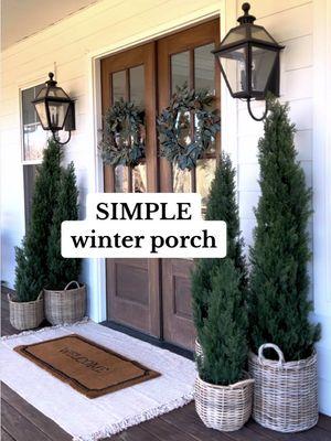 Here’s how I styled my “winter” porch last year…just the right amount of green to help get me through what can be a dreary time of year!  I’ve had these cedar trees for years (outdoors) and they have held up so well…even after being knocked down repeatedly by the wind! I use them all year round in different areas of our porch and back patio. I’m getting a new Welcome mat this year and hoping to put a fresh coat of stain on the porch. I’ve been putting it off for so long and it needs it bad! Then I’ll update this space, but I’m trying to decide if I should decorate my doors for Valentine’s Day or keep it neutral until spring 🤔🤔  You can also shop this reel by heading to my @shop.Itk link in my bio or https://liketk.it/52NQX . . . . . #frontporch #frontdoor #frenchdoors #frontdoordecor #porchdecor #farmhousestyle #whitefarmhouse #farmhousedecor #fixerupperstyle #modernfarmhouse #curbappeal #frontentry #frontdoors #ltkhome #liketkit #countryliving #joannagaines #modernfarmhousestyle #dreamhouse #countrylivingmagazine #betterhomesandgardens #cottagesandbungalows #southernliving #mybhghome #southernlivingmag #fixerupper #farmhousedesign #hgtv