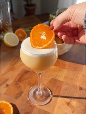 The new dining room and a Mandarin Almond Sour🍊🥃 Ingredients  2oz. Rye Whiskey  1 egg white  .75 oz. Mandarin Juice .5 oz. Lemon Juice  .5 oz. Orgeat Syrup (almond syrup) 2 dashes orange bitters  Add all ingredients to a shaker tin. Dry shake (no ice) vigorously for 30 seconds. Add ice, shake vigorously for 30 seconds. Double strain into a martini/nick and Nora glass. Garnish with an orange slice.  #whiskey #whiskeysour #cocktailrecipe #drinkrecipe #citrusseason #yum #winterrecipes #orgeat 