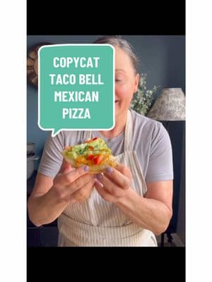 Here's a healthier, Weight Watchers-friendly version of Taco Bell's Mexican Pizza, packed with protein and fiber.  Makes 1 serving.  9 WW points.  If you count calories or macros, each one is 420 calories, 22 fat, 47 carbs, 44 protein and 24 grams of fiber. Ingredients: 2 low-carb tortillas (such as Mission or La Banderita) 1/4 cup fat-free refried beans 2 tablespoons Taco Bell sauce, divided 3 ounces lean ground beef taco meat (90% lean or higher) 2 tablespoons nonfat Greek yogurt 1 ounce cheddar cheese, shredded 1/4 cup diced tomatoes 1/4 cup shredded lettuce 1/4 cup diced red bell pepper Optional toppings: pickled jalapeños, cilantro Instructions: Prepare the Base Layer: Preheat your air fryer to 360°F (182°C). In a small bowl, combine 1 tablespoon of Taco Bell sauce with the refried beans. Spread the bean mixture evenly over one of the tortillas. Add the Fillings: Distribute the cooked taco meat over the refried beans. Sprinkle diced tomatoes evenly on top of the meat. Assemble the Pizza: Place the second tortilla on top of the layered fillings, pressing down gently to secure. Prepare the Topping: In a small bowl, mix the remaining 1 tablespoon of Taco Bell sauce with the nonfat Greek yogurt. Spread this yogurt sauce evenly over the top tortilla. Sprinkle the shredded cheddar cheese over the yogurt sauce. Cook the Mexican Pizza: Place the assembled pizza in the preheated air fryer. Cook at 360°F (182°C) for 5-7 minutes, or until the cheese is melted and the tortillas are crispy. Add Fresh Toppings and Serve: Remove the pizza from the air fryer and top with shredded lettuce, diced red bell pepper, and any additional desired toppings such as pickled jalapeños and cilantro. Slice into quarters and enjoy! This recipe offers a satisfying alternative to the traditional fast-food version, with only 9 Weight Watchers points compared to Taco Bell's 16-point version. Enjoy the flavors you love while staying on track with your health goals. #healthytacobell #tacobellmexicanpizza #quickdinners #DinnerIdeas #mealsforpickyeaters #weightwatchers #mybizzykitchen