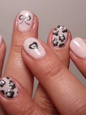 Pinky white nails with 3d pearl chrome flowers, bow, heart nail art . Products used: @GELCARE® cuticle softener @Gelish MINI ph bond* @Apres Nail primer @Kokoist USA mega stick base @Le Mini Macaron coconut yogurt* and licorice gel polish, Le Métallique chrome powder* @Kupa Inc  top coat @chanel.beauty No 5 hand cream @OPI - US cuticle oil . *pr #chromenails #nailinspo #nailart #easynails #diynails #vdaynails #valentinesnails #funnails #nailtutorial #3dnails #coquettenails #springnails 