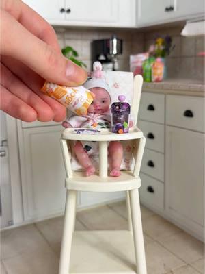 ✨ New addition to my miniature doll family!  Just welcomed this precious 3-inch silicone baby doll from Kazakhstan-based artist Kovalevadoll. I fell in love with her lifelike open eyes (my first one with open eyes!) and knew she'd look perfect in this tiny high chair setup.  Special moment unboxing her with my granddaughter Zara, who's been dreaming of reborn dolls since she was three! Full unboxing video on my other channel. 🎀 The details are incredible - from her cute face to those sweet little toes! Who else collects these miniature dolls? 💝 #miniatures #dollcollector #handmadedolls #siliconedolls #miniatureart #grandmalife