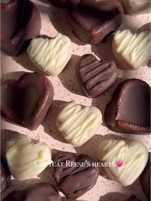 COPYCAT REESE’S PB HEARTS If you haven’t tried making your own Reese’s peanut butter hearts at home yet, it’s time you try! They are super easy to prepare, require only a hand full of ingredients, and are so delicious. Be sure to save this one for later, they can be made year round! Reese’s Peanut Butter Hearts: 1 cup organic peanut butter (substitute any nut or seed butter) 1/3 cup + 2 Tbsp coconut flour 1/4 cup maple syrup 1/4 cup melted refined coconut oil 2 tsp vanilla extract Pinch of salt 1/2 cup no sugar added chocolate chips 1/2 cup white chocolate chips 2 tsp refined coconut oil for melting chocolate Instructions 1. Mix peanut butter, maple syrup, melted coconut oil, vanilla extract in bowl until smooth and combined 2. Add in coconut flour, salt, and mix 3. Refrigerate the dough for 30 minutes 4. Add dough to greased heart molds and freeze for 10-15 minutes  5. Melt chocolate and white chocolate in separate bowls with 1 tsp coconut oil for each 6. Using a fork, dip hearts in melted chocolate, and tap off excess chocolate, and add to a lined baking sheet. 7. Transfer to freezer to let chocolate harden 8. Drizzle extra melted chocolate on top if you’d like 9. Store in fridge or freezer in an airtight container. I prefer to keep mine stored in freezer . . #reesespeanutbuttercups #peanutbutterlover #peanutbuttercups #valentinesdaytreats #valentinesdayfood #valentinesdaydessert #festivefood #nobakedessert #nobakerecipe #rawdessert #peanutbutterchocolate