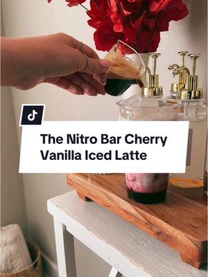 Nitro Bar Cherry Vanilla Latte 🍒✨ Recipe Inspo @The Nitro Bar  Espresso Orafio @Nespresso  Espresso Glass @Amazon  Vanilla Syrup @Torani  Recipe Cherry Vanilla Syrup 1 cup frozen cherries 1 cup water  1/2 cup sugar  4 pumps vanilla syrup (see directions) Latte  1-2 shots espresso 1-2 oz cherry vanilla syrup Ice 1 cup milk Directions  1. For the syrup, combine cherries, water, and sugar. Cook for 15 minutes.  2. Strain out cherries and transfer to a syrup dispenser. Add vanilla syrup and cool in the fridge.  3. For the latte, add ice, cherry vanilla syrup, and espresso. Enjoy! #nitrobar #cherryvanillalatte #cherryvanillasyrup #icedlatte #latterecipe #trending #Recipe #coffee #espresso #vanilla #cherry #coffeesyruprecipe #coffeebar #coffeeathome #homecafe #ValentinesDay #viralrecipe #viral #trend #fyp #valentinesdayrecipe #cafe #cafelivcakes #livcakes #ban #thenitrobar #baristatok #coffeetok 