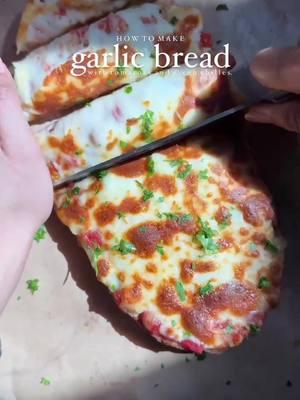 (ad) Cheesy Garlic Bread Recipe featuring @Red Gold Tomatoes   With roasted garlic, melted cheese, and a touch of spice, this recipe is a guaranteed crowd-pleaser that's easy to make and loaded with flavor. The perfect comfort food or game day recipe! 🎥 by @iramsfoodstory  INGREDIENTS:  1 loaf of Italian bread 1 (10 ounce) can Red Gold Mild Diced Tomatoes & Green Chilies 1 head of garlic 3 tablespoons neutral oil Kosher salt, to taste 1 tablespoon fresh chopped parsley 6 tablespoons softened unsalted butter 1 cup shredded mozzarella or cheddar cheese Did you know Red Gold can trace every can of tomatoes back to the actual field it was grown on? Truly quality your family can taste!  Shop Red Gold Tomatoes at a retailer near you https://ff.recipes/redgold-fy2025 #redgoldtomatoes #feedfeed #EasyRecipes #gameday #gamedaysnacks #cheesygarlicbread 