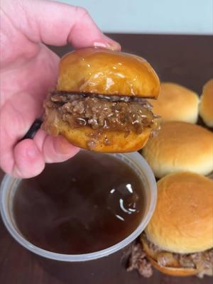 French dip sliders might be the best sliders I’ve made. These were so good! Recipe ⤵️ Au Jus: * Melt 3 tbsp butter over medium low heat, add in 1 sweet onion and cook for 15-20 minutes until the onions caramelize (stirring occasionally so the onions don’t burn) * Once the onions have caramelized, add in 2 cups of beef broth (the better quality = the better flavor) * Add 1 sprig of rosemary, 1 tbsp Worcestershire and salt and pepper to taste  * Simmer for 10 minutes and then strain through a fine mesh strainer  Sliders:  * Sauté 2 diced onion for 3-5 minutes until the start to softened * Add 2lb of shaved ribeye, seasoning with salt and pepper * Add @KING’S HAWAIIAN original Hawaiian slider buns to the griddle to toast * Chop the ribeye up finely, adding the onions back in once the steak is almost done cooking * Add Swiss cheese or white American cheese on top to melt  * Add to the bottom half of the sliders, topping with the top buns and this is ready to serve with the au jus * Dunk and enjoy!  #KingsHawaiian #slidersunday #frenchdip 	