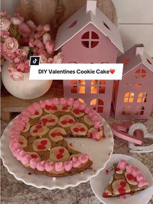 DIY Valentines day cookie cake! ❤️ ❤️  All you need is : Cookie dough Cheesecake pan Icing — Press chocolate chip cookie dough into pan. Then layer heart sugar cookies on top. Lightly press into bottom layer.  Bake at 350 degrees for 15-20 min. Or until it looks done..😂😂 Once it cools down, pipe icing around the edges! That’s it. Enjoy.💕💕 #ValentinesDay #valentines #vday #valentinesdiy #valentinesparty #valentinesfood #EasyRecipes #valentinesbaking #bakingtiktok #valentinesdessert 