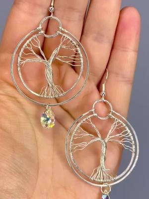 This is a pair of handmade tree of life wire wrapped hoop earrings. Made with a mix of sterling silver, and silver filled wire, and yellow crystal accents. Find these in my shop. 🌳💎♥️ #handmadejewelry #sollunaalchemy #handmade #botanical #wirewrappedjewelry #silverjewelry #sterlingsilver #treeoflife #treeoflifejewelry #hoopearrings #crystalearrings #hammered #metalwork 