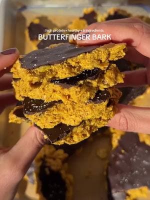 high protein BUTTERFINGER BARK that only uses 6 ingredients 🤭 butterfingers were oddly my favorite candy growing up, even though it seemed no one else felt that way. totally forgot about them until recently and had to make a high protein bark variation, which i can say without any doubt is my FAVORITE bark creation thus far!!! RECIPE 👇  Ingredients: 1/2 cup natural peanut butter 2 cups unsweetened cornflakes 1 scoop Vanilla Protein Powder 2 tablespoons honey 8 oz dark chocolate, melted  1 tablespoon coconut oil Flakey sea salt, for topping (optional, but I highly recommend) Instructions: 1. In a large mixing bowl, combine the Goode Health Vanilla Spice Protein Powder, natural peanut butter, unsweetened cornflakes, vanilla extract, and honey. Mix until well combined and the mixture sticks together. 2. Line a baking sheet with parchment paper. Spread the mixture evenly onto the parchment paper, pressing it down to form a thin, even layer. Aim for about 1/4 inch thickness. 3. In a microwave-safe bowl or using a double boiler, melt the dark chocolate with coconut oil until smooth and well combined. 4. Pour the melted chocolate over the peanut butter-cornflake mixture, spreading it evenly with a spatula to coat the entire surface. 5. Sprinkle flakey sea salt evenly over the melted chocolate while it’s still wet. 6. Place the baking sheet in the refrigerator or freezer for at least 30 minutes, or until the chocolate is set and firm. 7.  Once set, remove the bark from the refrigerator and break it into pieces. 8. ENJOY! (Store in an airtight container in the refrigerator for up to one week) #dessert #chocolate #butterfinger #Recipe #recipesoftiktok #healthysnack #highprotein #proteinsnack #proteindessert #peanutbutter #butterfingerbars 