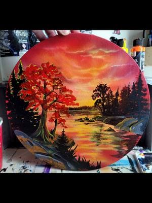 I painted up this little fire cracker of a round canvas tonight #happytrees #redtree #handpainted #bobross #landscapepainting #round #artwork #createxcolors 