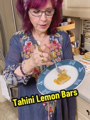 My recipe for Tahini Lemon Bars from our cookbook SIGNS & SEASONS (available as an ebook with 96 recipes): Makes 16 squares  The almonds, coconut and spices along with the rice syrup and a little lemon give enough variety and tang to lift the spirit. for the crust: ⅔ cup almond meal ⅓ cup coconut flour 2 tablespoons coconut oil 2 tablespoons rice malt syrup for the filling: 3 cups shredded coconut ¼ cup coconut milk 2 tablespoons coconut oil 3 tablespoons pure maple syrup 2 tablespoons tahini 1 teaspoon cinnamon ½ teaspoon nutmeg for the glaze: 1 tablespoon lemon juice 3 tablespoons rice malt syrup 2 tablespoons coconut oil 1 tablespoon tahini Line an 8-inch square cake pan with parchment paper. Combine the ingredients for the crust in a large bowl and stir to mix thoroughly. Add the mixture to the lined cake pan and press it evenly across the bottom. Refrigerate. Put the shredded coconut into the bowl of a food processor. Pulse-chop a few times. Add the remaining ingredients for the filling to the bowl of the food processor and pulse until smooth. Pour the filling into the chilled crust and smooth with the back of a spoon or offset spatula into an even layer. Freeze for an hour or two.  Combine the ingredients for the glaze in a small bowl and whisk until fully incorporated and smooth. Using a silicone pastry brush or the back of a spoon, smooth the glaze over the filling. Cut in 2 inch squares and bring to room temperature to serve. Will last in the refrigerator for a few days or in the freezer for a few weeks. #signsandseasons #cookbook #food #healthyfood #astrology #wellness  #mindbodyspirit #meditation #joy #innerpeace #bestsellingauthors #wholehealth #tarot #goddess #metaphysics #spirituality #healing #reiki #enchantment #foodforthought #harpercollins #chefjohnokas #amyzerner #montefarber