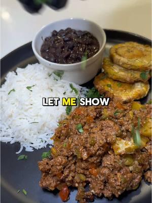 Authentic Cuban Picadillo 🇨🇺🔥 recipe ⬇️ 2 tbsp olive oil 1 medium yellow or white onion, finely diced 1/2 red bell pepper, finely diced 1/2 green bell pepper, finely diced 1 tbsp tomato paste 4 garlic cloves, finely chopped 2 tsp cumin 2 tsp oregano Salt and black pepper to taste 2 bay leaves 1/2 cup dry white wine 1 1/2 pounds ground beef 5 oz can tomato sauce 1/3 cup raisins 1/2 cup green pitted olives, sliced plus 2 tbsp brine 1 large Yukon Gold potato, peeled and cut into small cubes In a large pan, heat up olive oil on medium high heat until shimmering. Add onion & bell peppers. Sauté until softened. Incorporate your fresh garlic, seasonings, tomato paste and bay leaves. Cook down for a few minutes to remove any acid or bitter taste from tomato paste. Use dry cooking wine to deglaze any bits from bottom of the pan. Once most of it has evaporated add ground beef. Break up with a wooden spoon and until browned. Season to taste with salt & pepper. Pour in tomato sauce, olives (along with its brine), raisins and potato cubes. Mix until combined. Simmer covered for 10-12 minutes until potatoes are fork tender. Tostones (Fried Green Plantains) 2 green plantains Avocado oil spray Peel and slice your plantains into 2 inch chunks. Thoroughly spray with oil. Air fry 390F for 10 min. Flattened each piece. Spray with oil again and air fry for another 10 min at 390F. #picadillo #cubanfood #groundbeef #blackbeans #plantains 