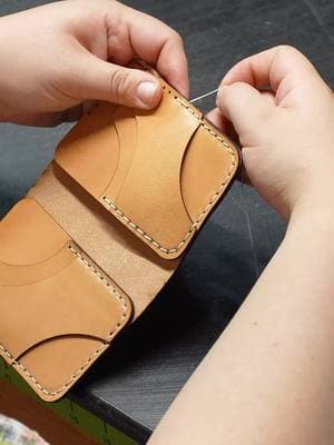 Hand stitching a Togo Wallet Togo Wallet: Tan Colorway | 3-4 oz. full-grain leather | Hand stitched | Closed Dimensions 4.5" x 3" | 4 card pockets - 2 hidden card & cash slots | Link in bio to shop now #leatherwallet #wallet #handmadeleather #handmade #leather