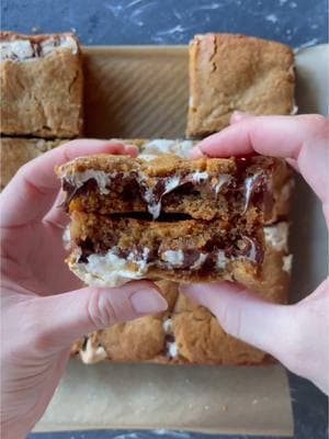 You need these chewy, gooey nostalgic treats in your life! Peanut Butter S'mores Blondies are marbled with lightly toasted marshmallow fluff and studded with chocolate chips. Get the easy recipe at handletheheat.com/peanut-butter-smores-blondies #dessert #blondies #chocolate #nostalgic 