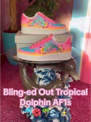 Blinged-Out Tropical Dolphin AF1s ✨🌴🌺 I created these custom sneakers for my client Rhonda ✨ Her likes include Dolphins🐬, Pink Plumeria Flowers🌺, and Bling✨ and said the rest was up to me and to surprise her with the final product! Let me tell you, his is a girl after my own heart🤩🤩🤩 so I had so much fun creating these for her! and as you can tell from my three different sets of nails… I spent forever and a day designing and making these because I wanted them to be a perfect tropical dream🌴☁️ This unboxing video says it all!!!! 🥹 @SupremeGoddess  What should we name these sneakers?!🐬🌺🌴🌊🥥 Leather Paint, Deglazer, and Finisher: @Angelus Direct  Shoe glue: @GEMIFLY  Rhinestones: @BlingeeThingee  . . . . #airforce1 #customsneakers #hawaiianflowers #bedazzled #blingedout #airforce1custom #tropicalvibes  #lisafrankvibes #coconutgirlaesthetic #customsneakers#customshoes #lisafrank #lisafrankforever #CapCut 