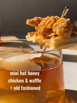 This might be my new favorite cocktail garnish EVER! We're onto the second week of our mini garnish series with @Mike’s Hot Honey, and we present the Mini Hot Honey Chicken & Waffle with an Old Fashioned! 🔥 #ad The sweet heat from Mike's Hot Honey is the prefect pairing with a classic dish turned miniature. Here's how to make both: • Mini Hot Honey Chicken & Waffle • Waffle triangle Fried chicken  Drizzle w/ Mike's Hot Honey • Hot Honey Old Fashioned • 2 oz bourbon .75 oz Mike's Hot Honey Syrup 2 dashes angostura bitters Stir w/ ice Strain over large ice cube Garnish w/ Mini Hot Honey Chicken & Waffle Enjoy! You can find Mike's Hot Honey in the honey aisle at your local grocery store! #thatsthespirits #oldfashioned #chickenandwaffle #chicken #waffle #mikeshothoney #minigarnish #garnish #drinkrecipe #cocktail