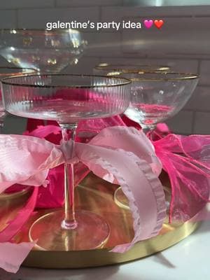 Tying pink bows on glasses is my new favorite party trick 🩷❤️ I bought ribbon in different shades of pink + designs and tied bows around the stem of some of my glasses!It’s the easiest and prettiest addition to your Galentine’s or Valentine’s Day party! #partyideas #partyplanning #partydecor #galentinesparty #galentines #bowsbowsbows 