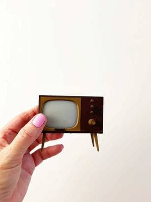 Who else remembers gathering around a TV that looked just like this? What shows would you have been watching? 📺  📺 Step back in time with this adorable find - a vintage TV that's actually a salt and pepper shaker! Those mid-century vibes with the gold trim and classic legs take me right back to the era of I Love Lucy and The Twilight Zone.  But plot twist... this tiny television isn't just for show - it's actually a clever salt & pepper duo! 🧂✨ Found this gem at an estate sale while hunting for miniatures for my dollhouse scenes. Don't you just love when something is both adorable AND functional? Every time I go estate sale hunting, I'm on a mission to find these perfectly-scaled treasures that can tell stories in my miniature world. This one's definitely going to be the star of a tiny mid-century living room setup! 🏠 #miniatures #vintagevibes #dollhouse #estatesalefinds #midcenturymodern #saltandpepper #tinytreasures #diorama #antiquing #vintagestyle #retrohome #dollhouseminiatures​​​​​​​​​​​​​​​​