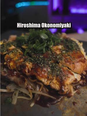 The Hiroshima style okonomiyaki is an iconic street food originating from, you guessed it, Hiroshima!  Kinda sloppy yet so delicious, Oppenheimer would've fought harder to not drop the bomb there.  Maybe. [Batter Mix Ingredients] 1 premade dashi packet, 600ml water (or follow instructions on box) ~60g flour ~100ml dashi broth [Ingredients] Batter mix & dashi broth above. 1/2 handful of grinded bonito flakes ~150g cabbages Handful of bean sprouts Octopus leg (optional) Salt & pepper Handful of tempura crumbs 3 thin slices of pork belly 1 packet yakisoba noodles 1 egg [Toppings] Okonomiyaki sauce Aonori Chopped scallions 1.  Make dashi broth using pre-made packet. 2.  Make batter mix by mixing dashi broth & flour. 3.  Heat & coat pan/plate with oil (low-medium heat). 4.  Pour batter mix enough to make a thin circle of your desired size. 5.  Lighly cover in bonito flakes, then pile on chopped cabbages. 6.  Add bean sprouts, salt & pepper, tempura crumbs, pork belly, a little bit of batter mix. 7.  Flip it over, add water along the edges and steam for a bit.  Occasionally press down. 8.  Meanwhile, cook a packet of yakisoba noodles & chopped octopus with a little bit of dashi broth. 9.  Mix it up, make a circle, place the cake on top. 10. Crach open an egg to make a rough omelet, place everything on top.  Flip it over. 11.  Add the toppings (egg side on top). #okonomiyaki #yakisoba #japanesefood #streetfood #cooking #Recipe #fyp 