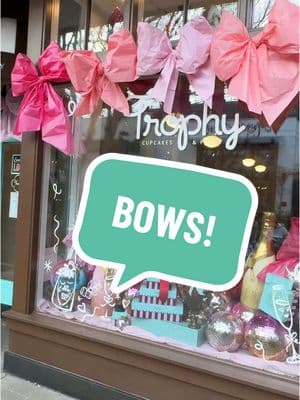 Love is in the air..and bows🎀 Have you been to our @University Village shop  lately? 🫶 #TrophyCupcakes #bow #ValentinesDay #bows #diybow #LoveAndFriendship #UniversityVillage #windowart #SweetestEra