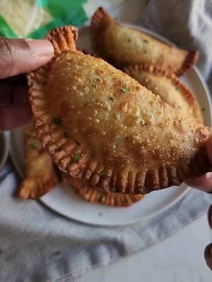 Celebrate on game day with these crispy, cheesy Beef & Cheese Empanadas! Packed with flavorful ground beef, seasoned to perfection, and stuffed with @Cabot creamery Cheddar Shreds for that rich, melty goodness. Did you know? Cabot Cheddar is naturally lactose-free, so you can enjoy all the cheesy deliciousness without the worry! #cabotpartner #ad #cabotcheese #cabotcreamery @Cabot Creamery Cooperative  Perfect for snacking, parties, or anytime cravings—who’s grabbing one? Save this recipe for later & tag a friend who needs to try it! Ingredients: 1 lb ground beef 1/4 cup diced onion 1 tsp salt 1/2 tsp black pepper 1 tsp garlic powder 1/2 tsp cumin 3 tbsp Sofrito with tomato 1 cup beef broth 1 tsp chopped cilantro 1 cup Cabot Vermont Shredded Cheddar Cheese  16-18 empanada wrappers   In a pan, cook ground beef over medium heat until browned. Drain excess fat. Add onions, salt, pepper, garlic powder, cumin and sofrito with tomato. Sauté for 2 minutes. Stir in beef broth. Simmer until thickened, then mix in cilantro. Let cool. Place filling in the center of each empanada wrapper. Top with shredded cheese. Brush edge with water and then fold. Seal edges with a fork. Fry until golden brown or bake at 375°F for 20-25 minutes.