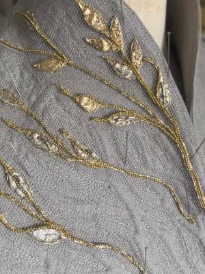 I finished the first section of gold embroidery for Galadriel!! Just pinned to the gambeson for now! It took a little bit to hit my stride with the technique for these tendrils but I am feeling very confident to dive into the remaining three hoops! #tolkien #trop #ringsofpower #embroidery #cosplay #tolkientok #handmade #lotr #lordoftherings 