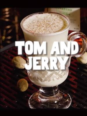 The hottest winter cocktail in the Midwest:  Tom and Jerry Batter 3 eggs (whites and yolks separated) ¼ teaspoon cream of tartar 1 cup sugar ½ oz. dark Jamaican rum ¼ teaspoon of vanilla extract Cocktail 1 oz. dark/aged rum 1 oz. Cognac or brandy 1–2 tbsp of batter 5 oz. hot whole milk Garnish: grated nutmeg Method: Separate 3 egg yolks and whites and set aside. In a bowl, whip the egg whites with cream of tartar until stiff peaks form. In a separate bowl, beat the yolks with sugar, rum, and vanilla. When the yolk mixture is completely combined, gently fold it into the egg white mixture. Keep refrigerated. Add rum, Cognac, and batter to a ceramic mug or tempered glass mug. Slowly top with milk while stirring constantly. Grate nutmeg over the top. 🎥 Jill Petracek #cheersmxj #tomandjerry #hotdrinks #winterdrinks #eggs #eggnog #classiccocktails 