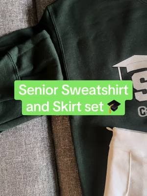 Custom Senior sweatshirt and skirt set- great for those senior pics and outfit for graduation day! We love being apart of these graduates’ day by making them more memorable with custom grad items! Let us help you make your next event even more special and memorable✨#fyp #grad #seniorskirtset #highschoolgrad #collegegrad #seniorpics #2025graduate #seniors #graduation 